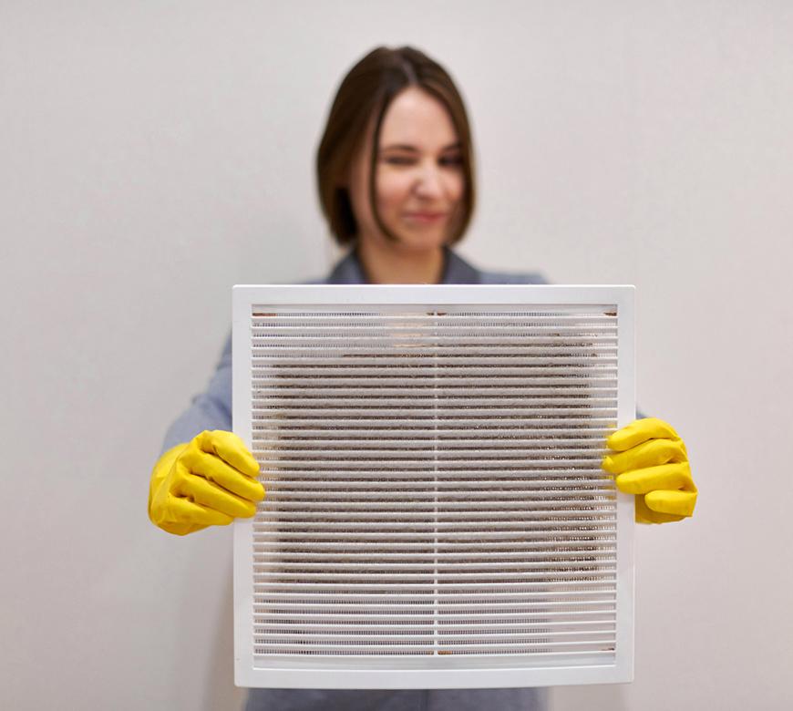 Nashville Woman Holding Dirty Vent Before Dryer Vent Cleaning Project